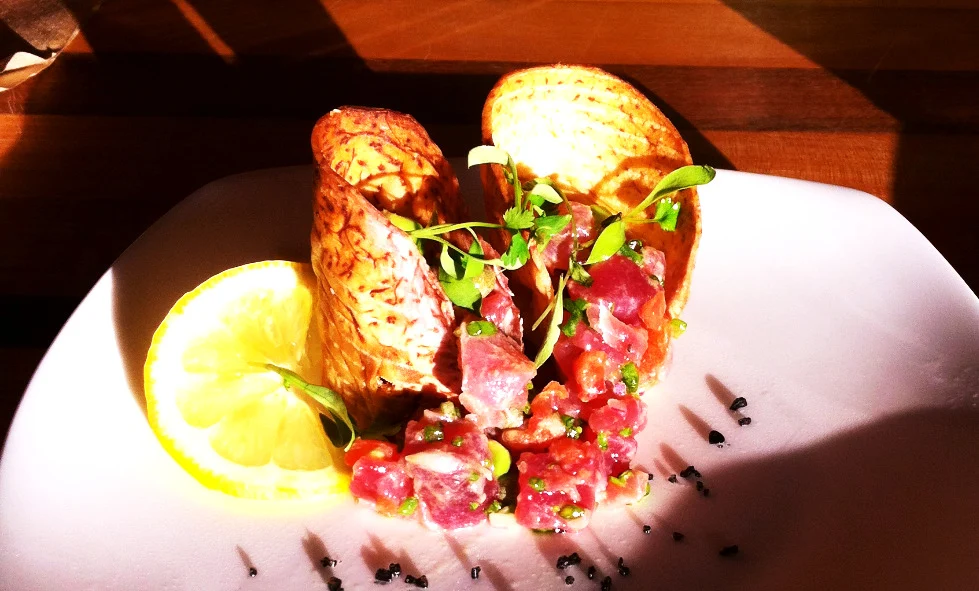 An ahi appetizer with toast and bright green garnish